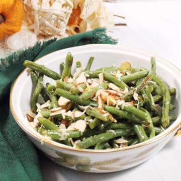 Bowl of air fried green beans with green napkin.