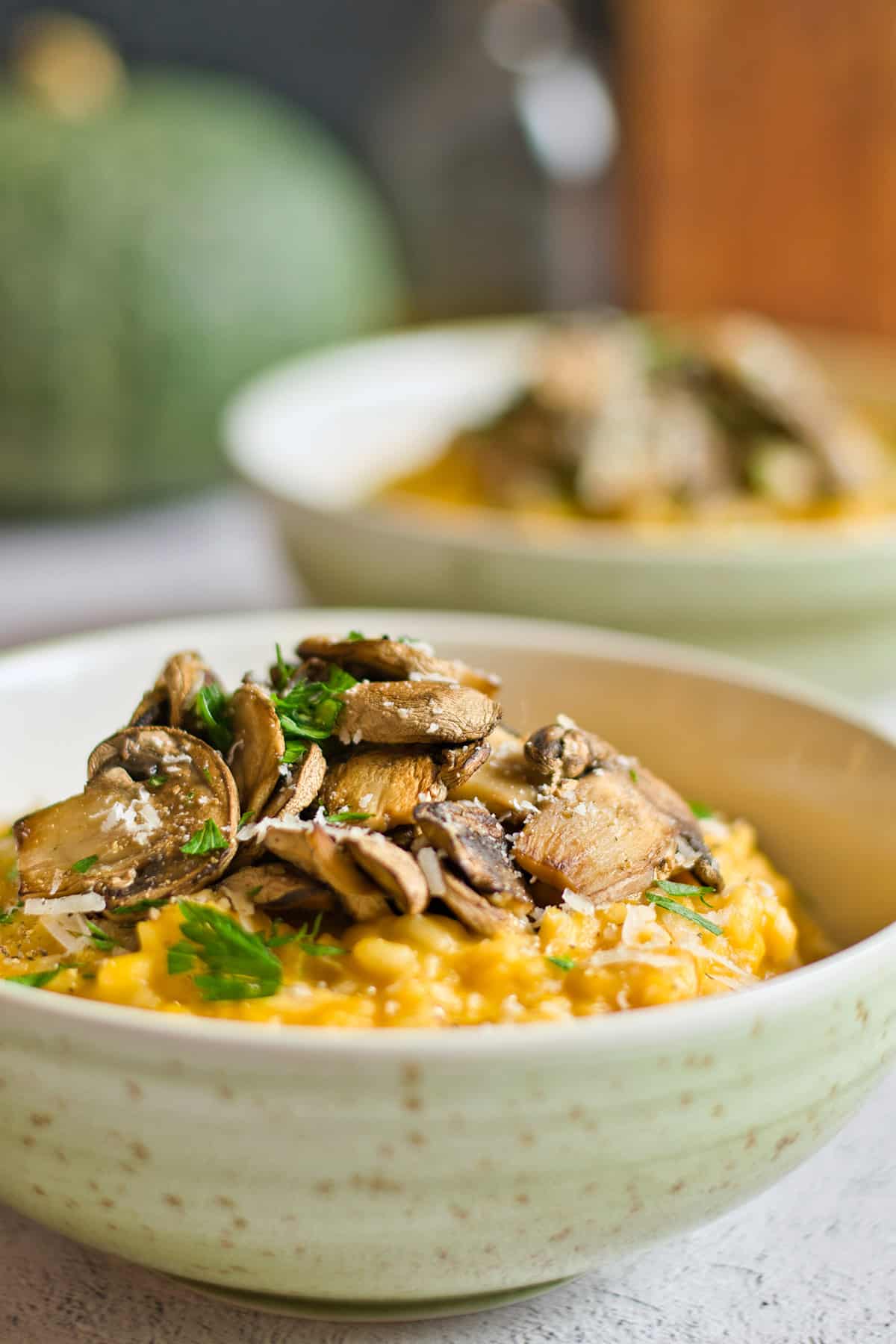 Garnishing top of risotto with fried mushrooms.