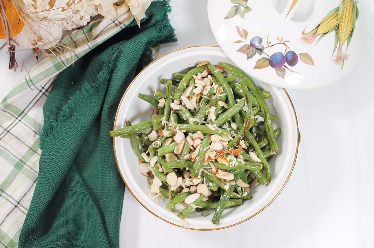 Overhead of green beans in white dish.
