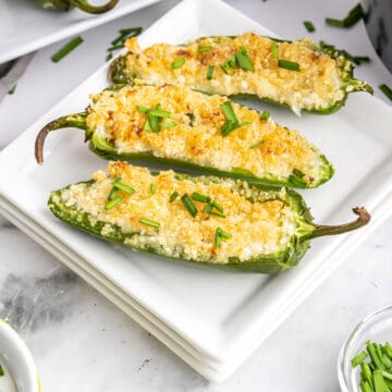 Three air fried jalapeno poppers on plate.