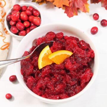 Overhead of cranberry sauce with orange wedges.