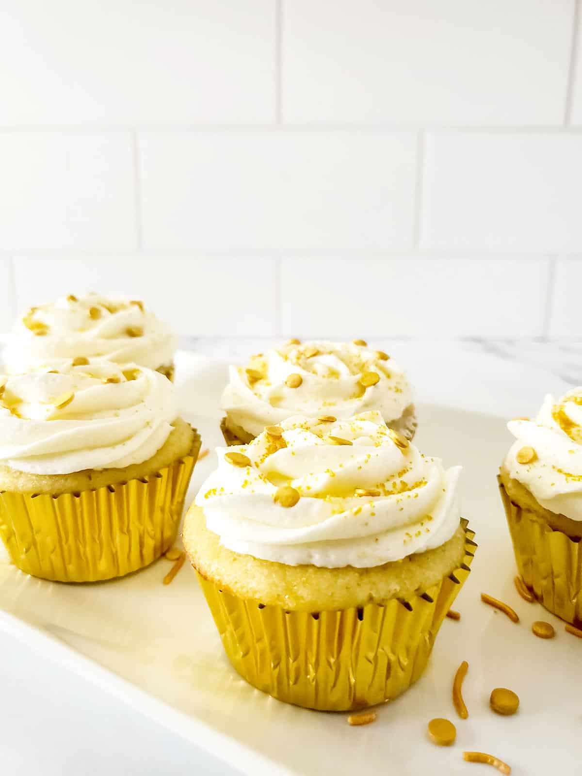 Closeup of frosted cupcakes with champagne frosting.