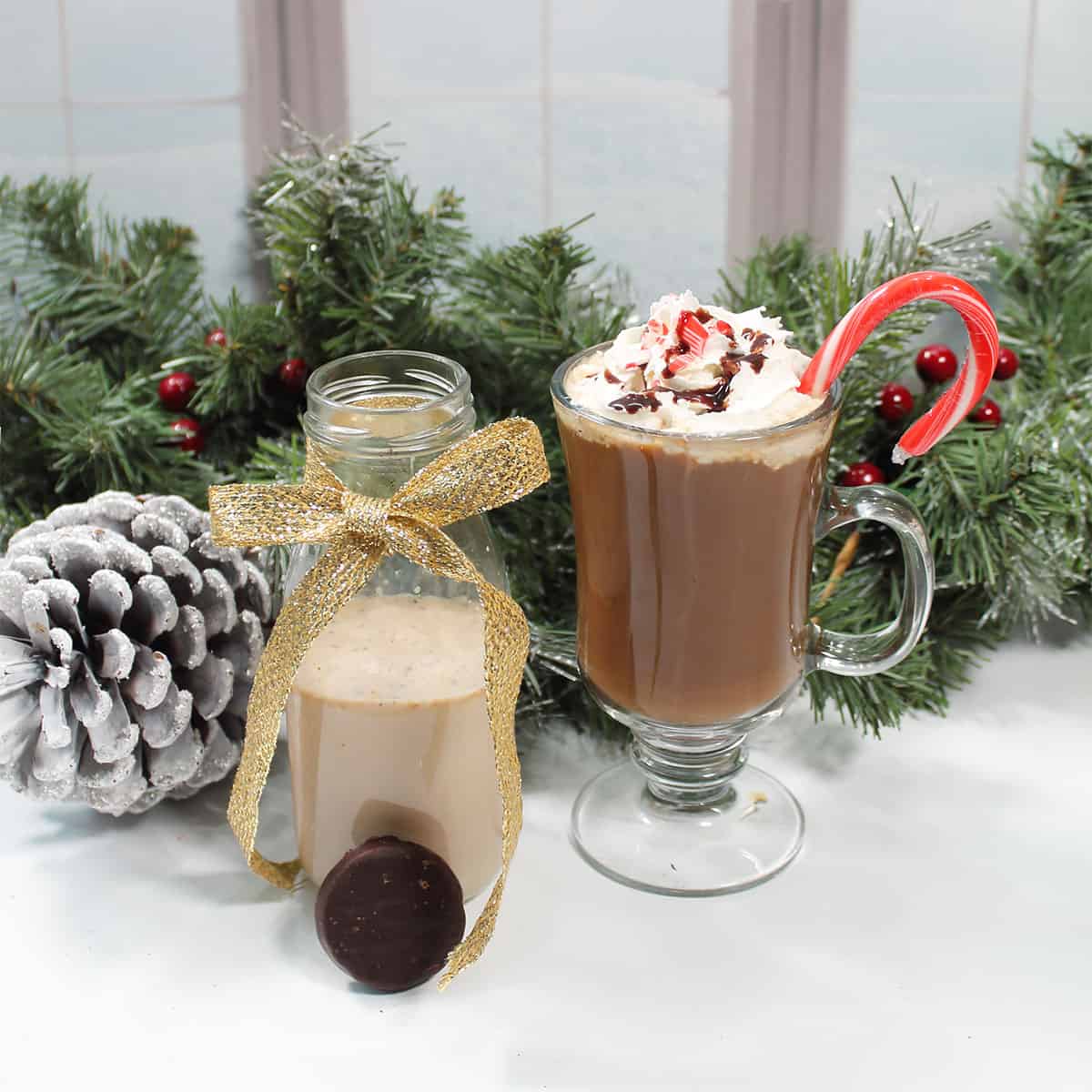 Peppermint mocha coffee creamer in bottle next to mug of coffee.