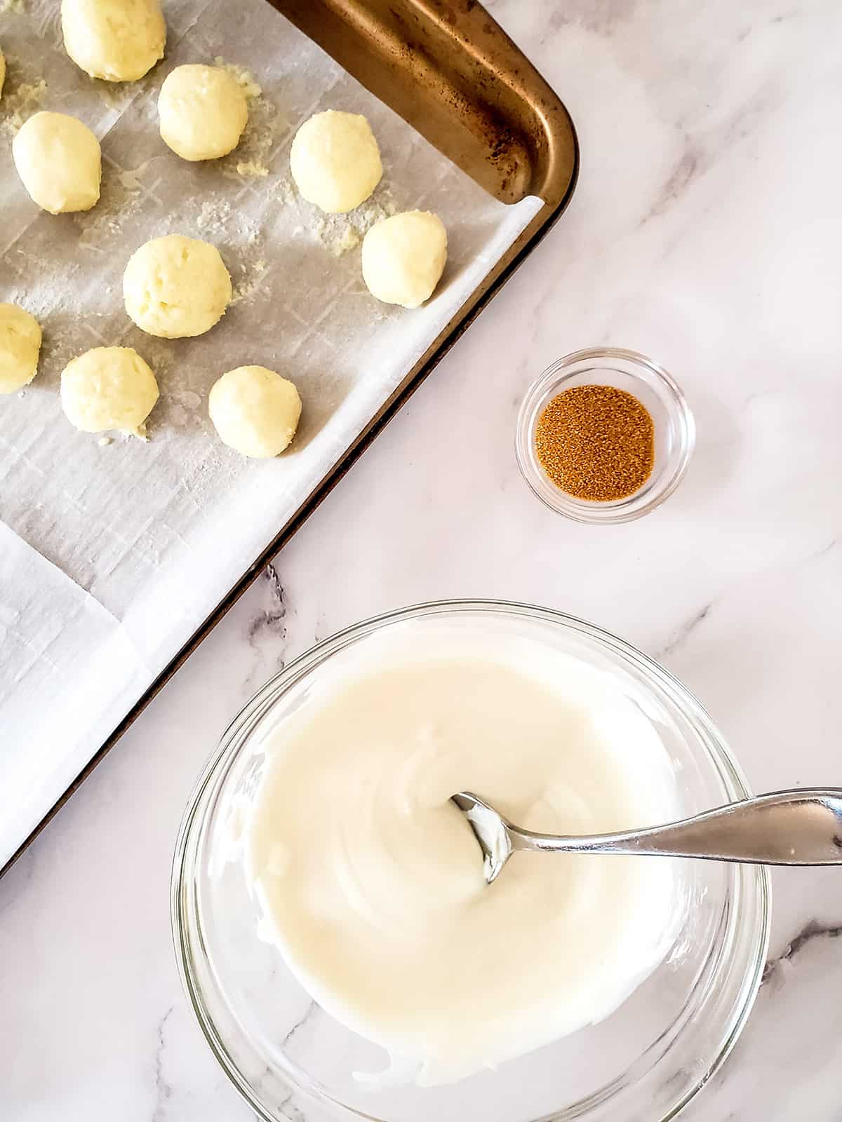 Melted white chocolate with rolled truffles.