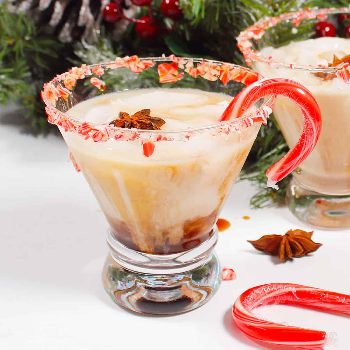 closeup of single peppermint white Russian cocktail with candy cane.