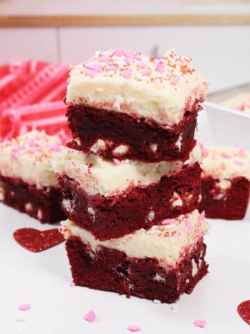 Stack of three brownies with red and pink towel.