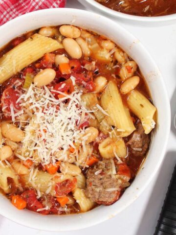 Overhead of bowl of hamburger soup with grated cheese on top.