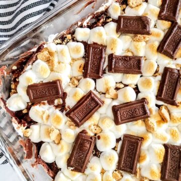 Finished treats in baking dish with chocolate bar on top.