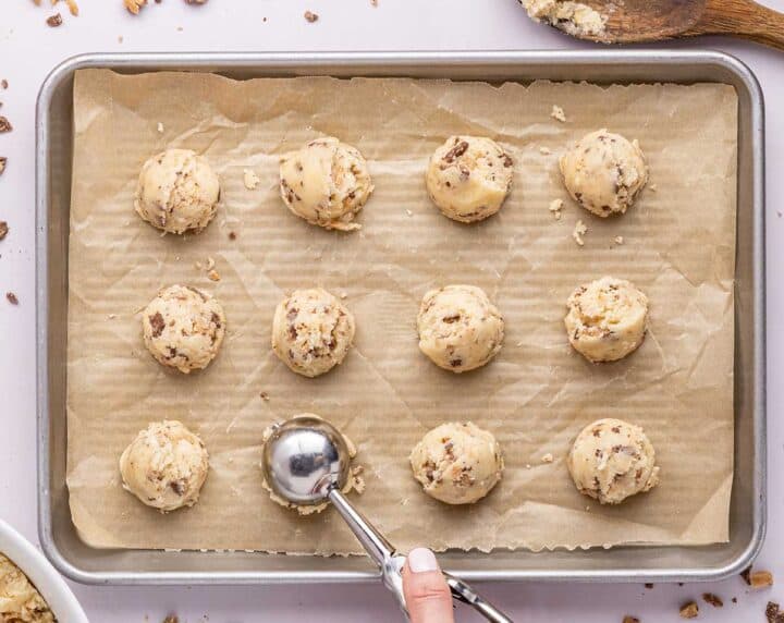 Heath Bar Cookies 2 Cookin Mamas   Heath Bar Cookies Scooping Cookie Dough Onto Baking Sheet 720x572 