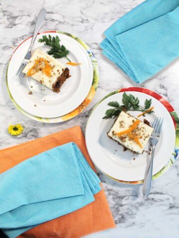 Two plated servings of carrot cake.