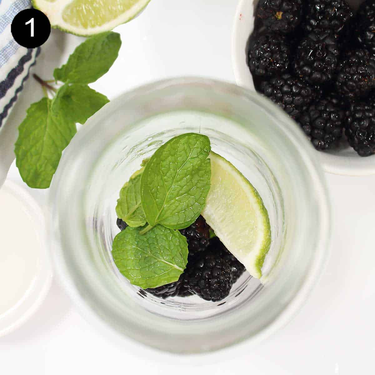 Step 1 - place mint, lime and blackberries in cocktail shaker.