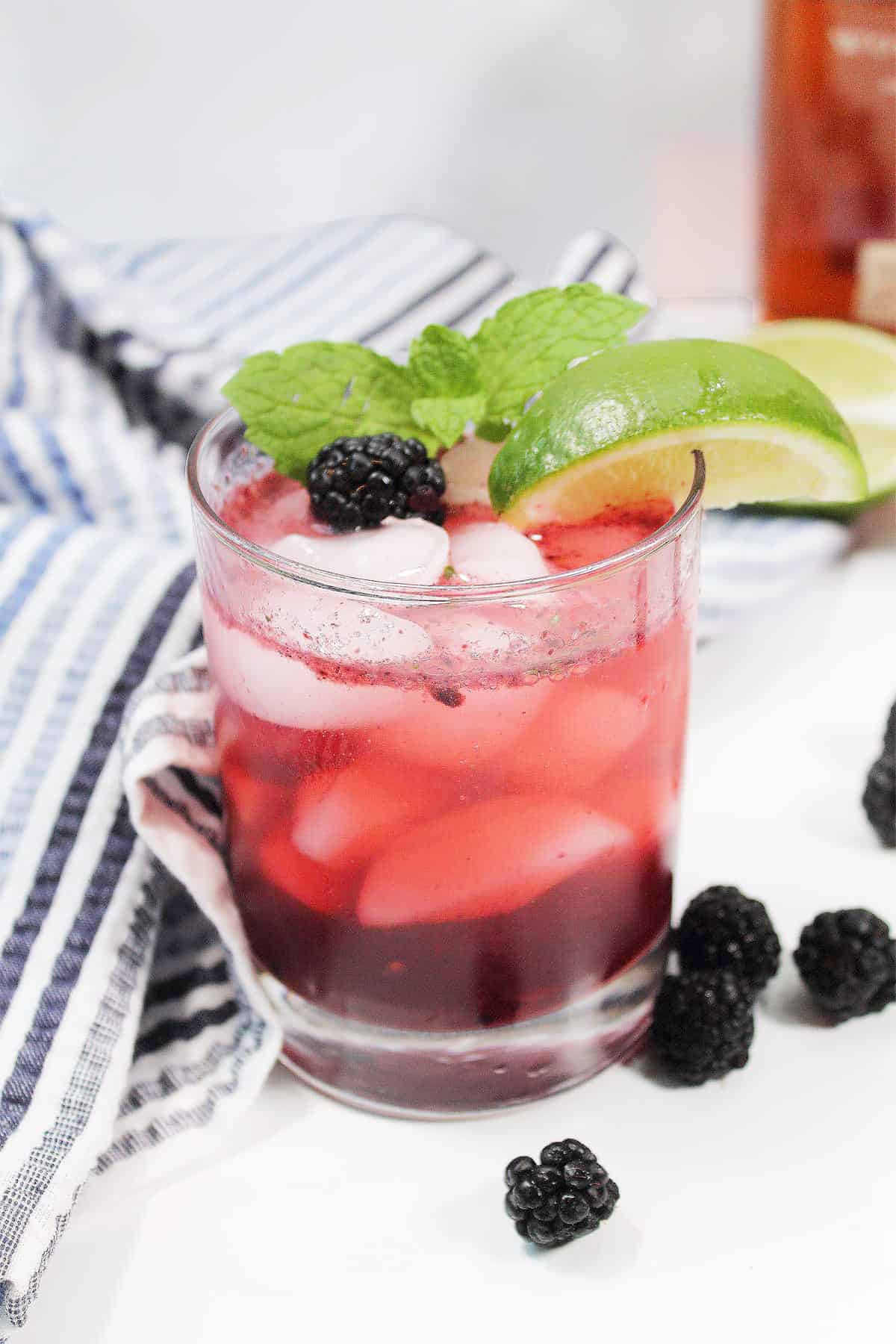 Single drink on table with mint and lime garnish.