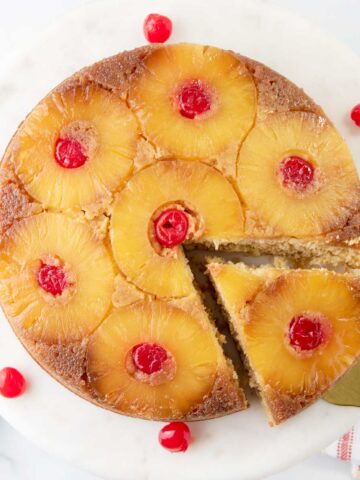 Overhead of finished pineapple upside down cake with a slice cut out.
