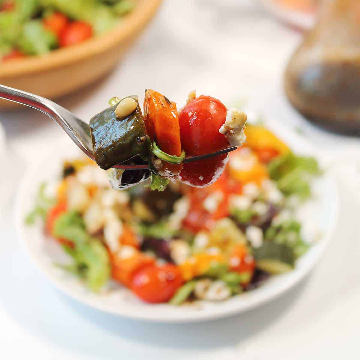 Bite of roasted veggie salad on fork.