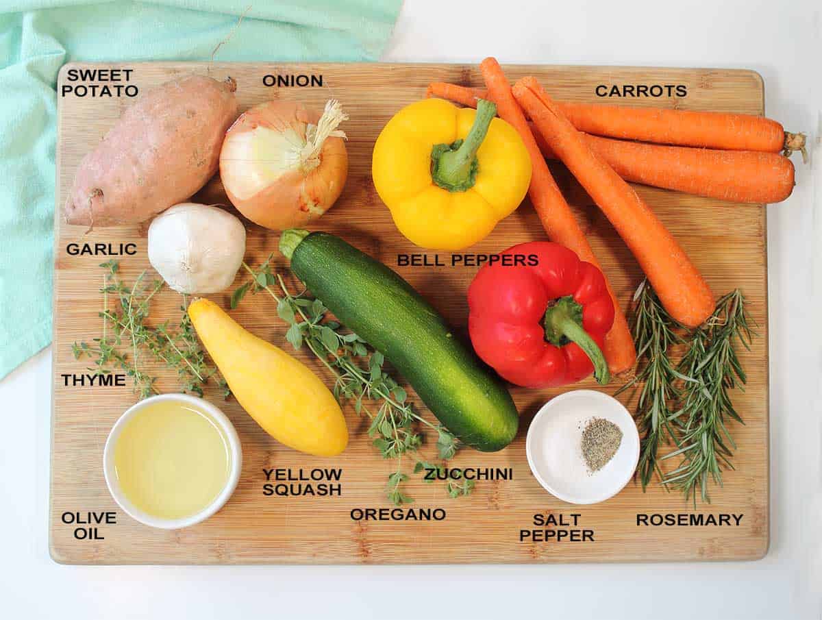 Roasted vegetable ingredients on cutting board.