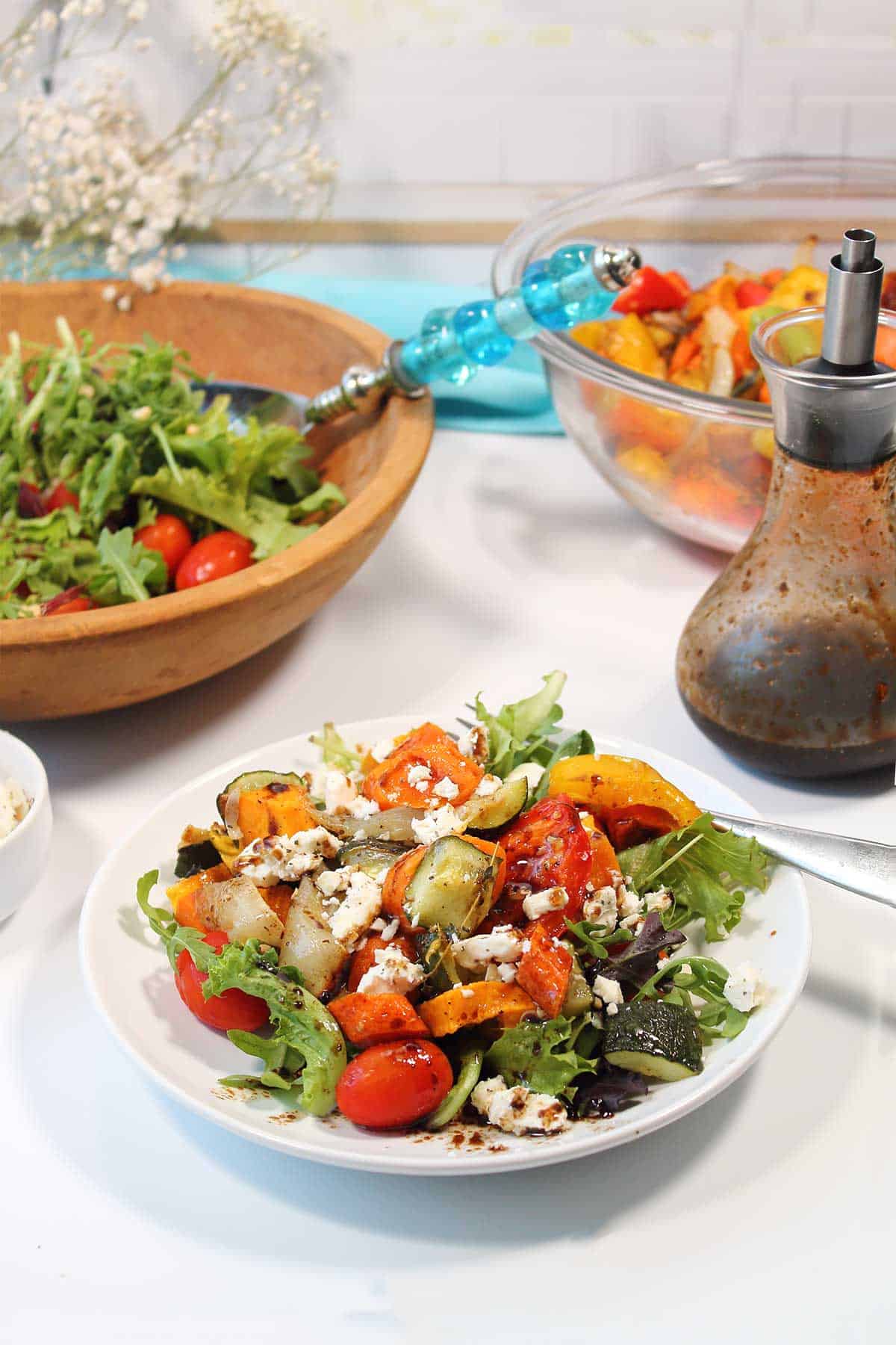 Roasted Vegetable Salad plated with balsamic vinaigrette in back.