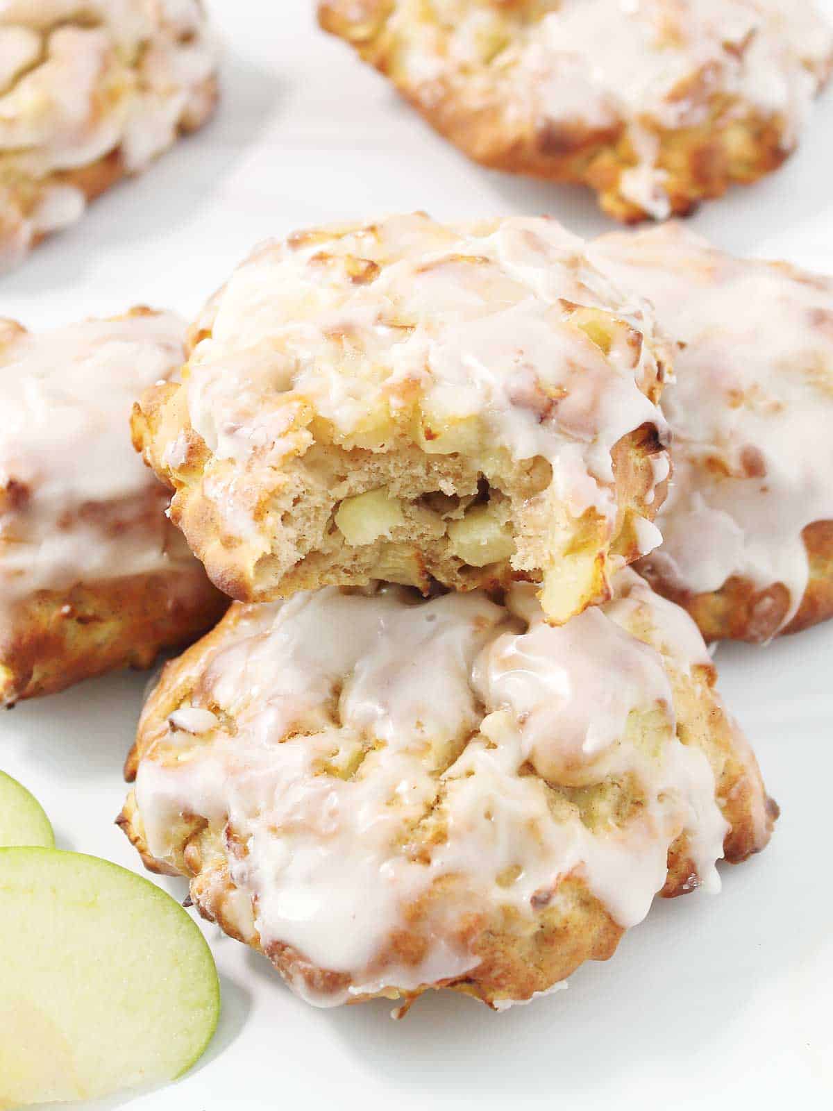 Stacked air fried apple fritters with a bite out of one.