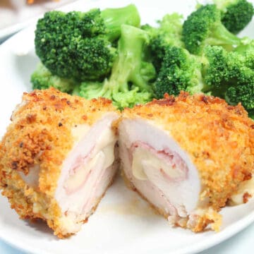 Halved air fryer chicken cordon bleu with broccoli.