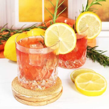 Two whiskey sours with cranberry.