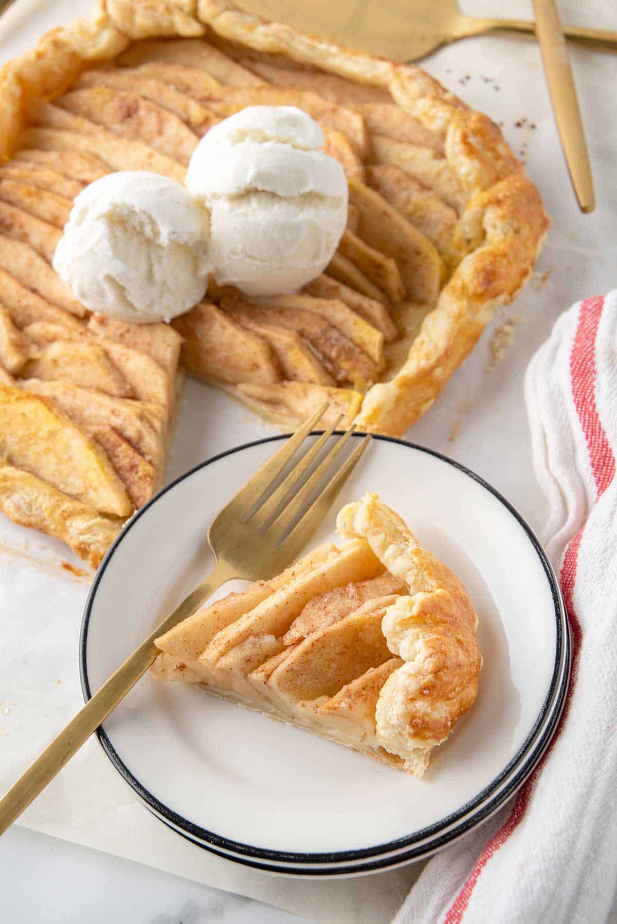 Apple Puff Pastry Galette with slice on plate.