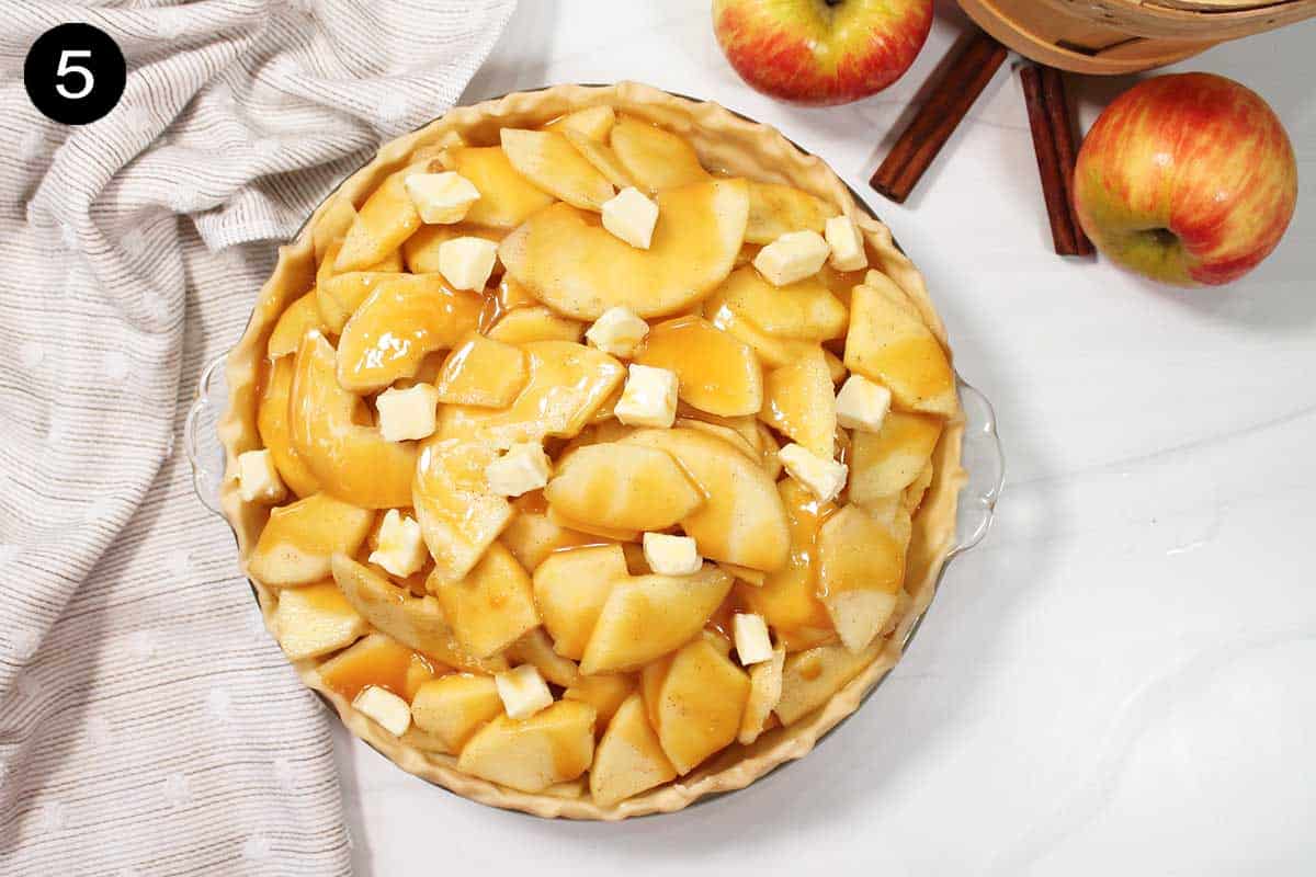 Overhead of caramel apple pie in pie shell covered with caramel sauce.