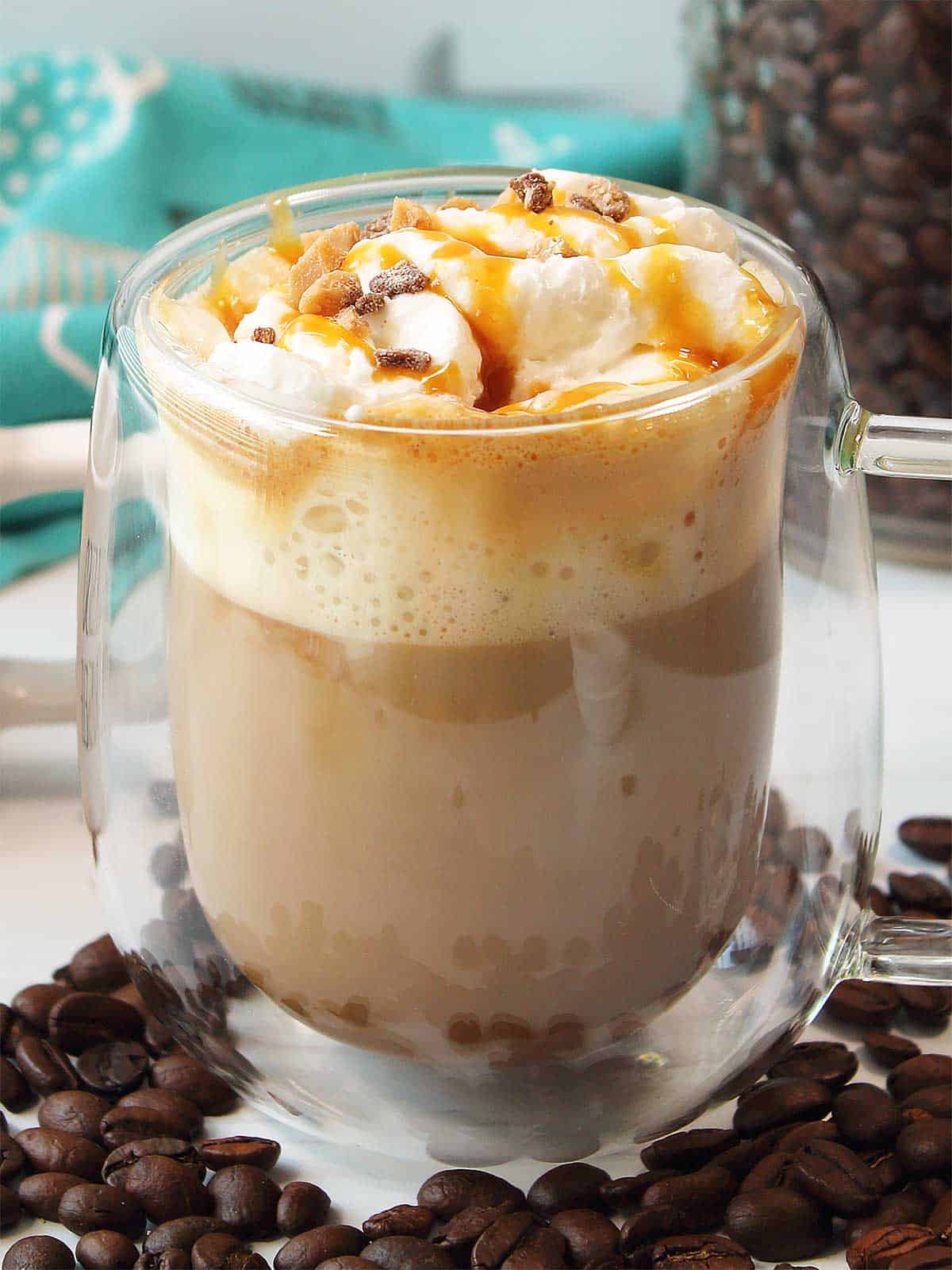 Copycat Starbucks Creme Brulee Latte with whipped cream and toffee bits.