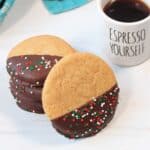 Coffee cookies stacked by cup of espresso.