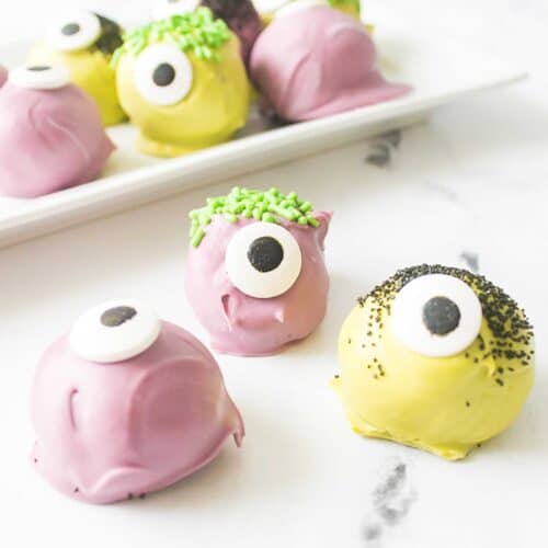 Three monster Oreo truffles in front of platter.