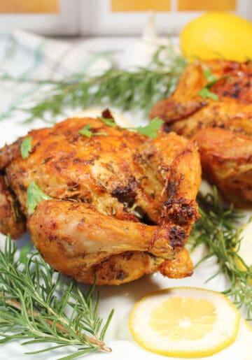 Closeup of air fried Cornish hen with rosemary.