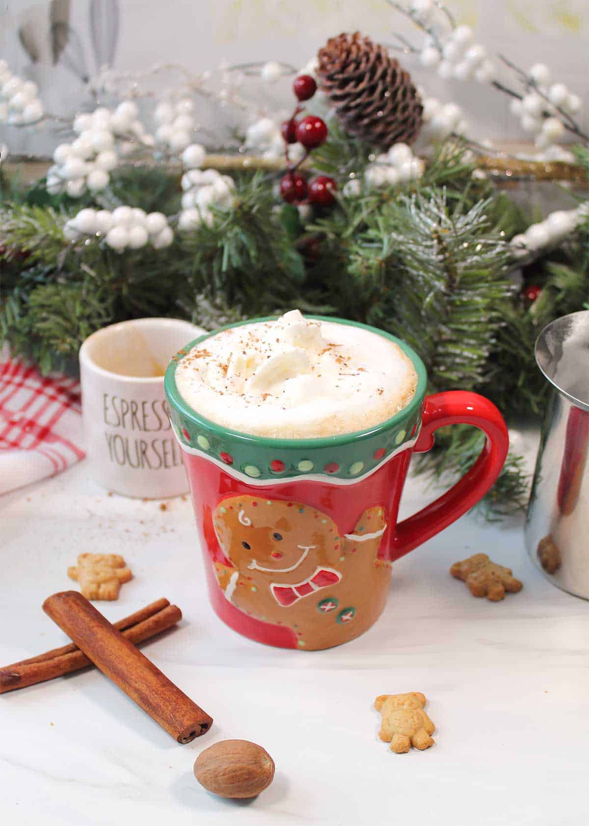 Gingerbread Latte in gingerbread mug by holiday garland.