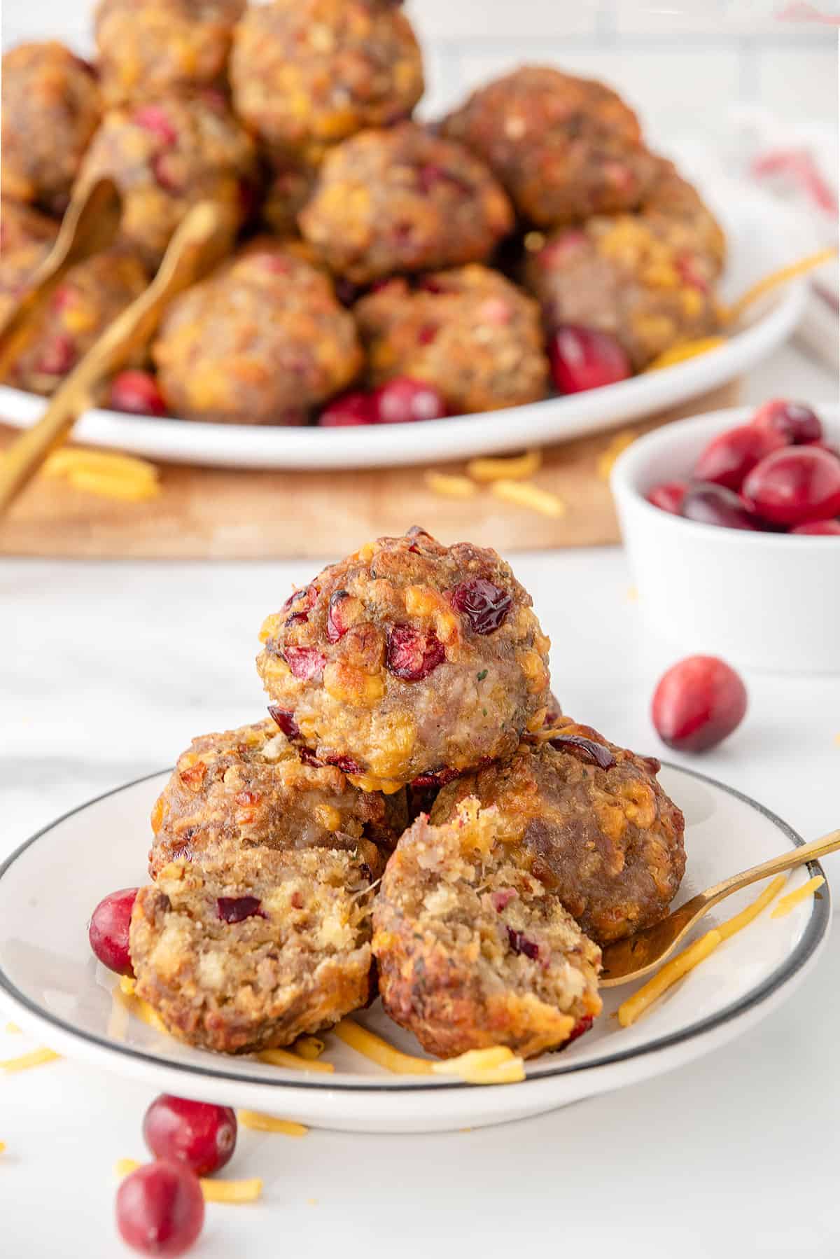 Air fryer stuffing balls on serving plate with platter in back.