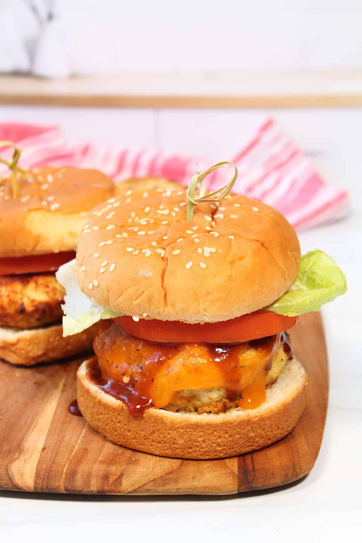 Two air fryer chicken burgers on buns.