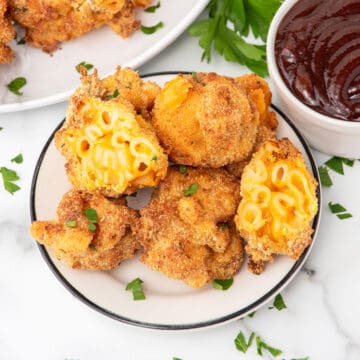 Mac and cheese balls serving with one halved.