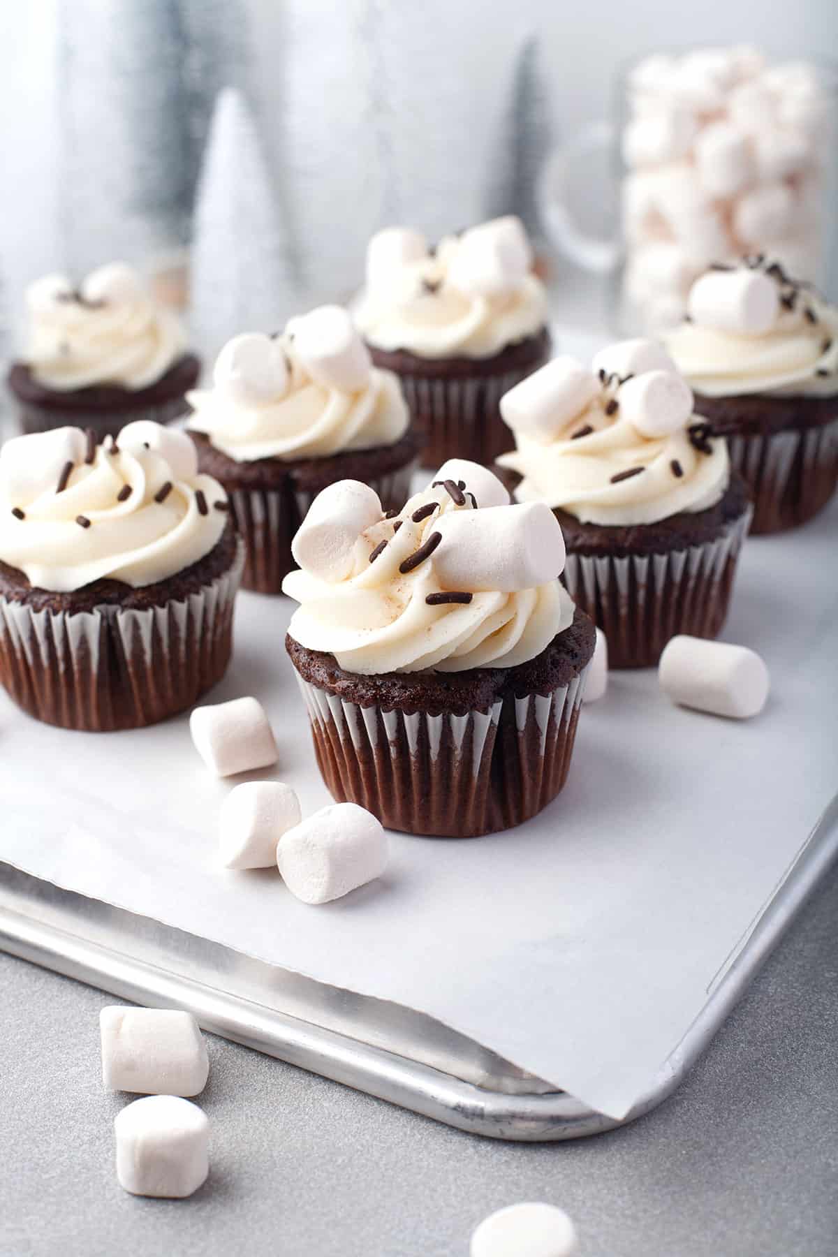 Hot chocolate cupcakes with marshmallow frosting on back of cookie sheet.