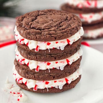 Stacked oreo cookie sandwiches with crushed peppermint.