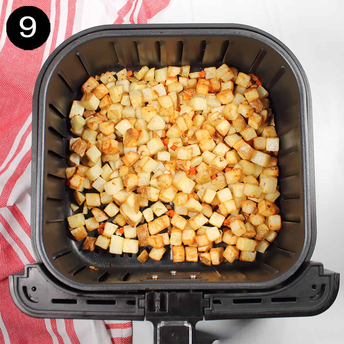 Crispy home fries in air fryer basket.