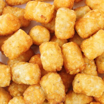 Closeup of air fried frozen tater tots.