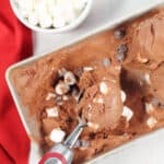 Scooping ice cream out of loaf pan.