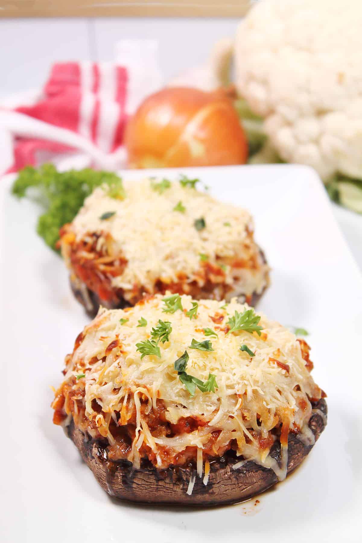 Two Stuffed Portobello Mushrooms with ground beef on platter.