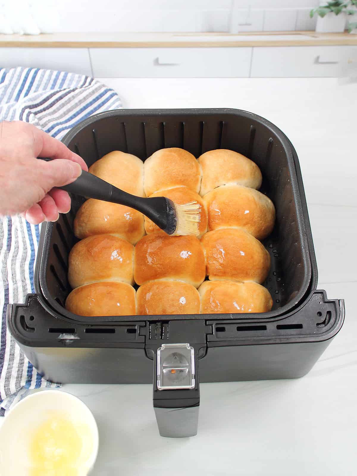 Brush the top of the rolls with melted butter.