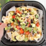 Grabbing a hot nacho chip from the air fryer