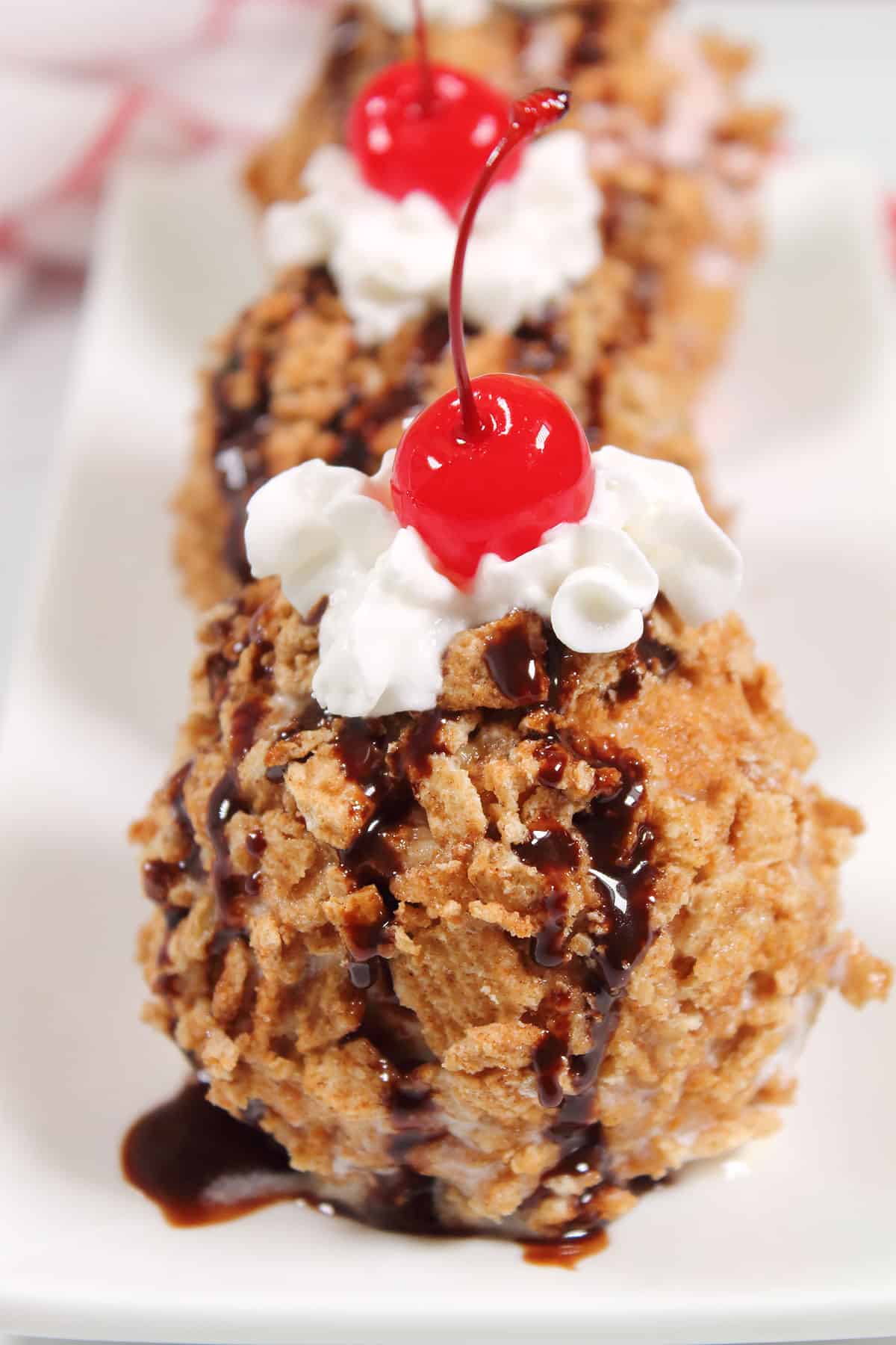 Closeup of air fryer fried ice cream with sundae toppings.