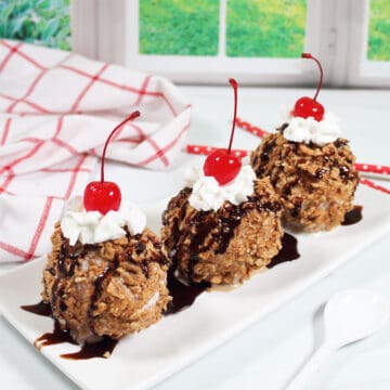 Three air fryer fried ice cream treats on a platter.