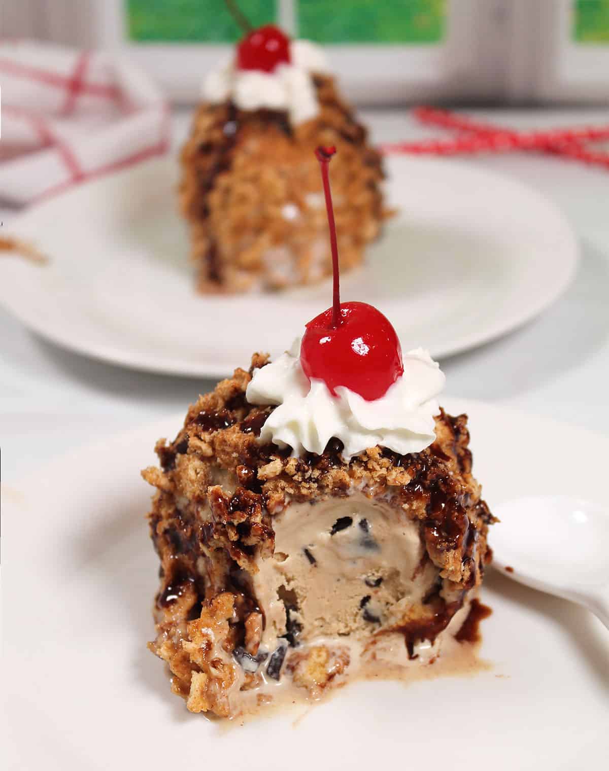 Fried ice cream with cinnamon toast crunch with bite out of it.