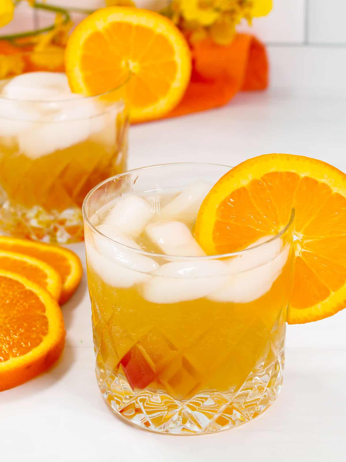 Sparkling Amaretto Sour with orange slice and cherry.