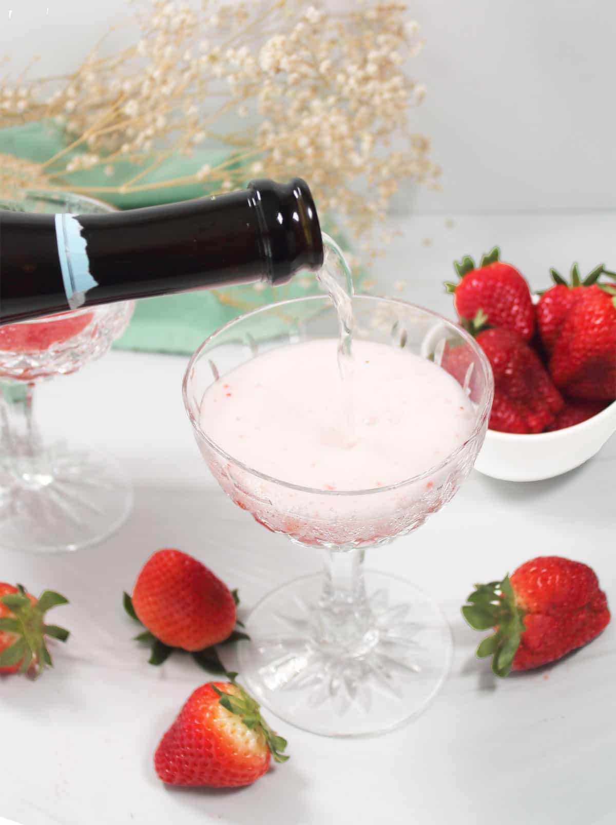 Pouring prosecco into champagne glass.