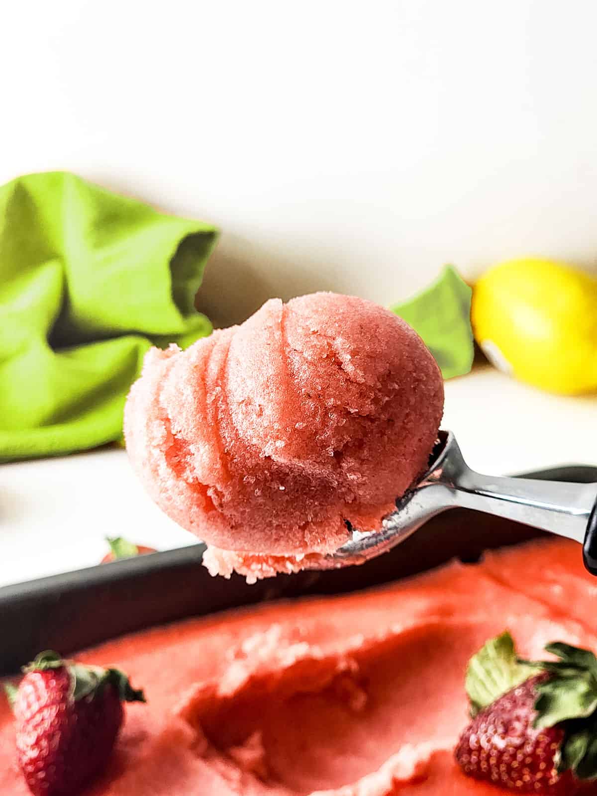Holding scoop of sorbet over loaf pan.