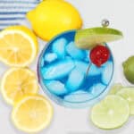 Overhead of Smurf drink with lemons and limes.