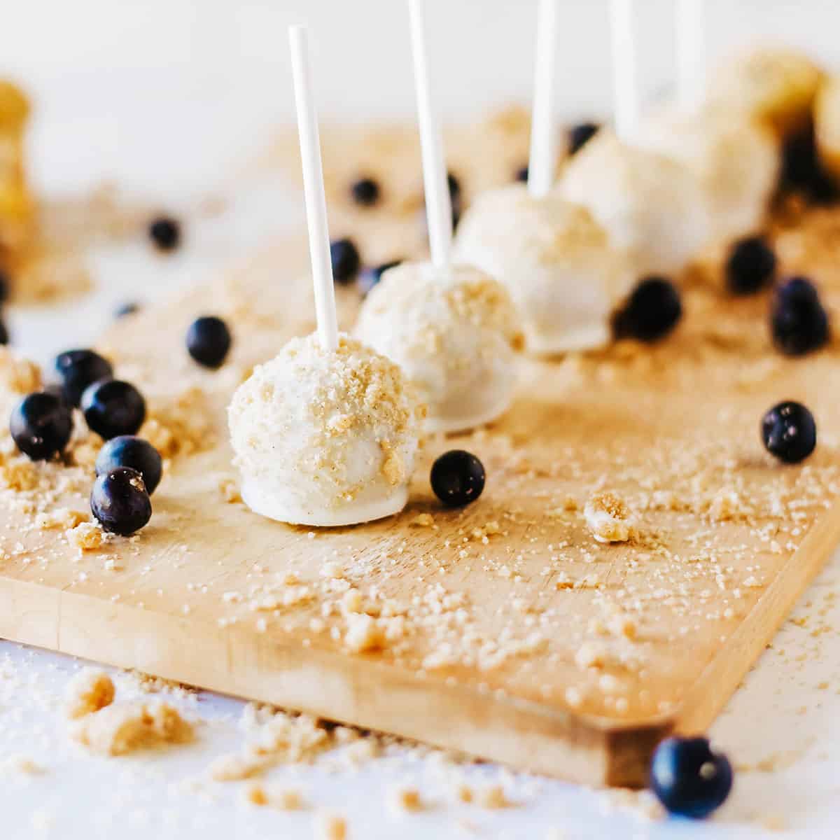 Finished cake pops with scattered blueberries.