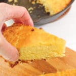 Holding slice of the best buttermilk cornbread.